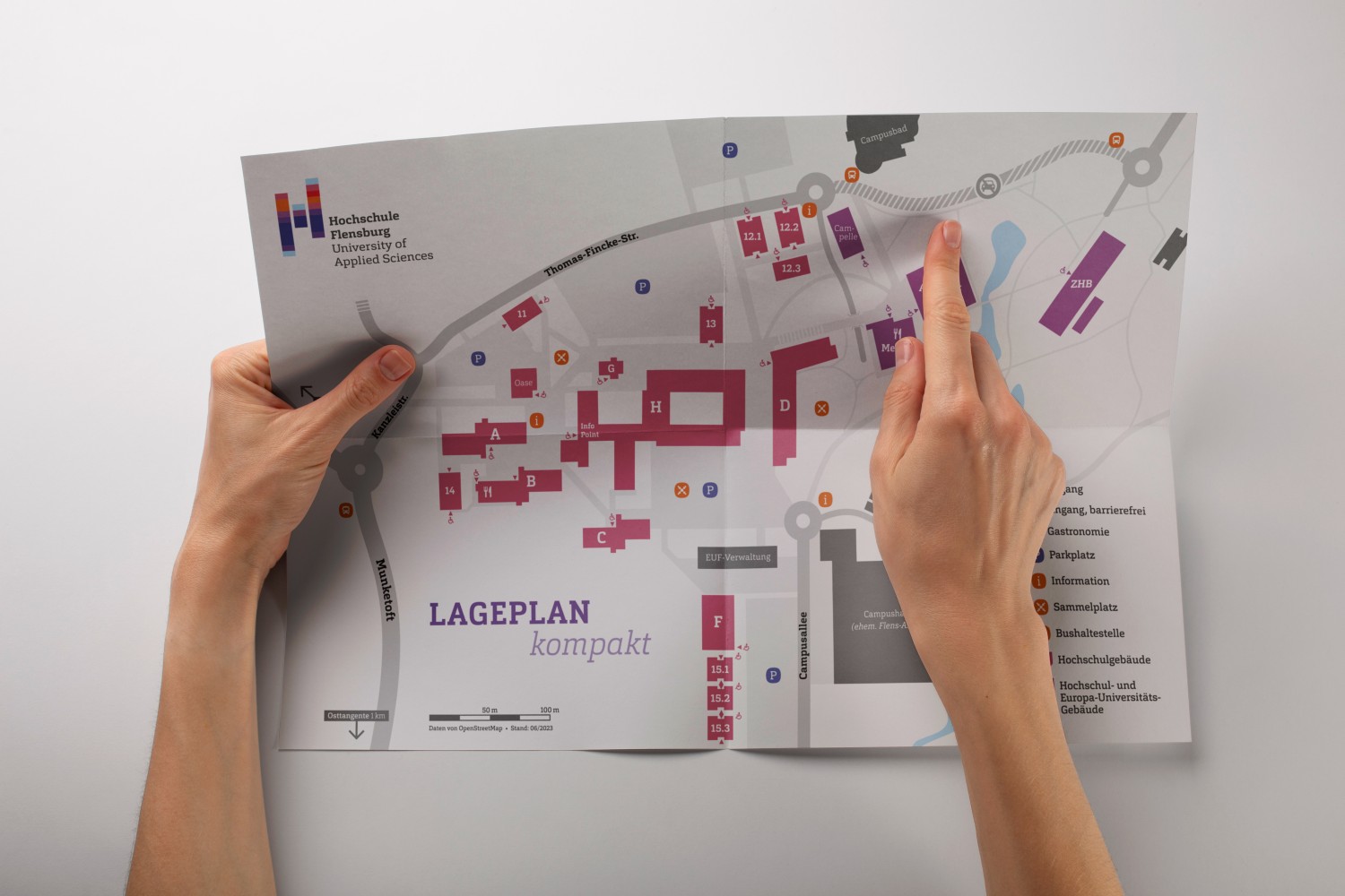 Mockup on which the campus map is held in hand